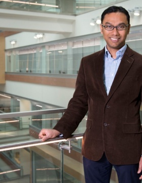 Pinaki Sarder standing in medical school atrium. 