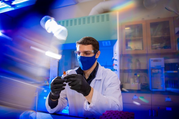 Zoom image: Zacheriah Gernold, UB chemistry PhD student, is part of a team that is leveraging analytical chemistry to study whether persistent chemicals, including PFAS, are present in the eggs of various bird species. He is pictured holding a vial containing freeze-dried material from abandoned double-crested cormorant eggs collected from around Lake Erie. Credit: Douglas Levere / University at Buffalo 