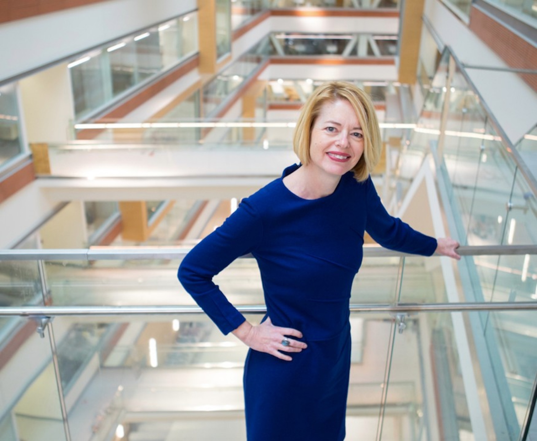 Kelly Hayes McAlonie standing in a modern building. 
