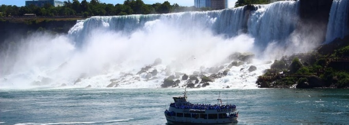 Niagara Falls with a tour boat below it. 