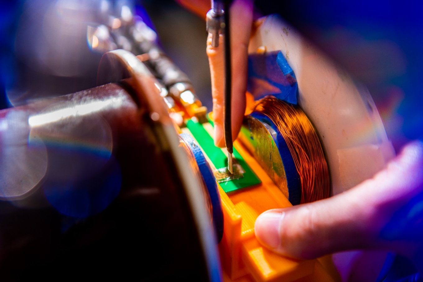 Zoom image: Scientists use a ferromagnetic resonance testing unit to measure the magnetism of a magneto-ionic material (pictured on the green board below a testing unit probe).&nbsp;Credit: Douglas Levere / University at Buffalo 