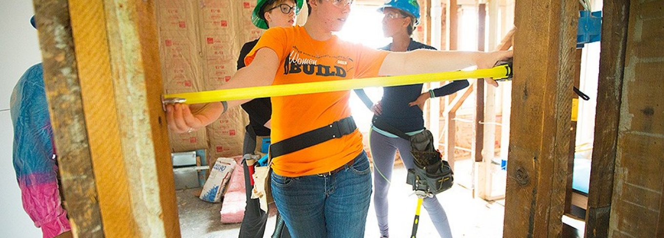 A student takes a measurement inside a Habitat for Humanity house that UB architecture students worked on in 2016. Photo: Douglas Levere.