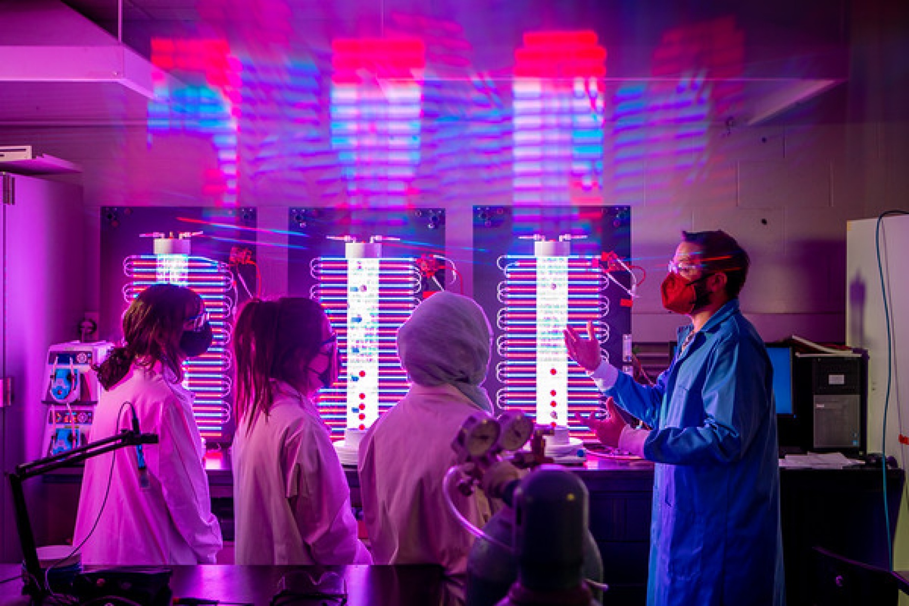 Zoom image: Students prepare to test wastewater for COVID-19 in the lab of engineering researcher Ian Bradley, right. Photo: Douglas Levere 