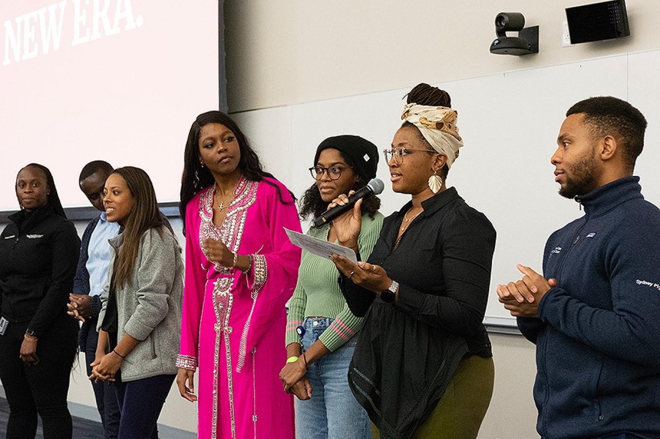 Zoom image: Last semester, Sydney Johnson, then vice president of the Student National Medical Association, was at the microphone during the group's annual Taste of Culture event. Photo: Sanra Kicman 
