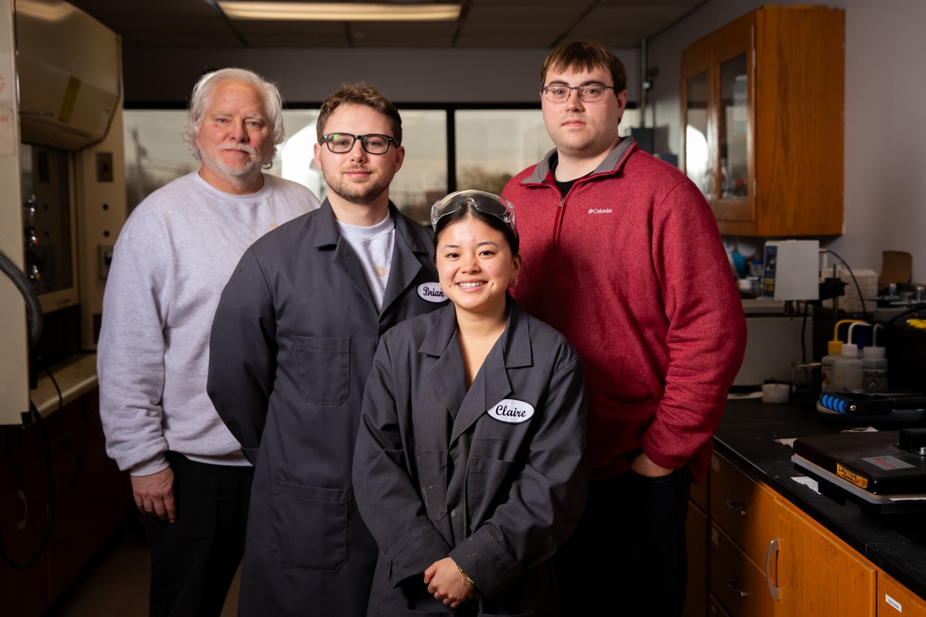 Zoom image: (From left) Copprium team members Edward Tierney, Brian Bischoff, Devin Angevine and Claire Farry at the company's lab space in the UB Incubator @ Baird. Photo: Meredith Forrest Kulwicki/University at Buffalo 