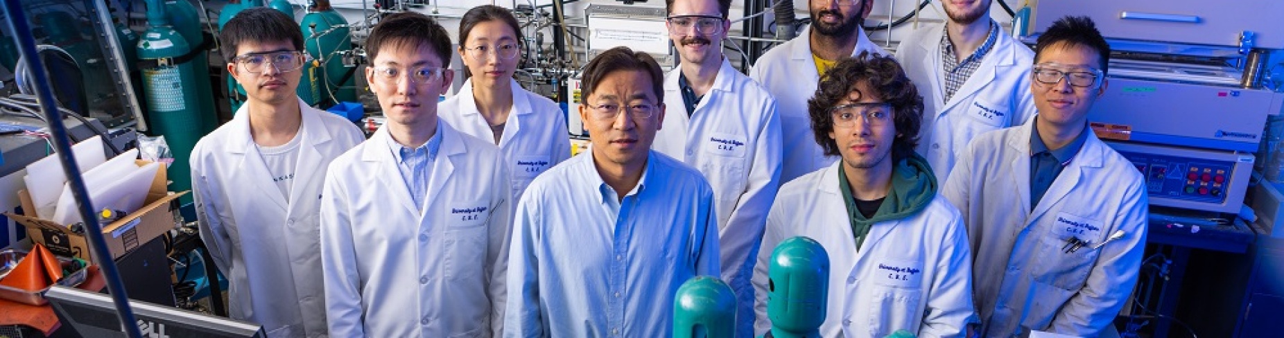 Gang Wu stands with eight students in his University at Buffalo lab.
