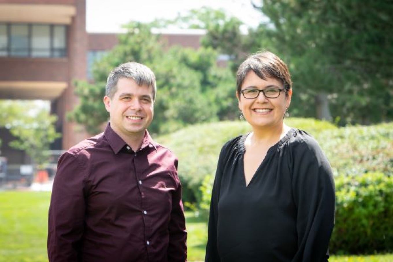 Corey Schimpf (left) and Matilde S&aacute;nchez-Pe&ntilde;a, both assistant professors of engineering education, stand together outside on UB's North Campus. Photo: Meredith Forrest Kulwicki, University at Buffalo. 
