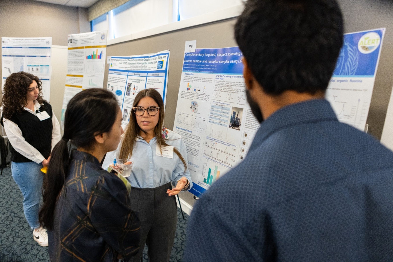 Zoom image: Karla Rios Bonilla, a chemistry graduate student in Aga's research group, explains her research. Photo: Douglas Levere/University at Buffalo 