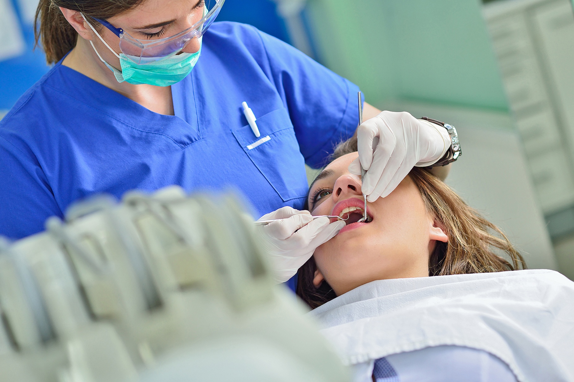 A patient receives a dental exam from a dentist.