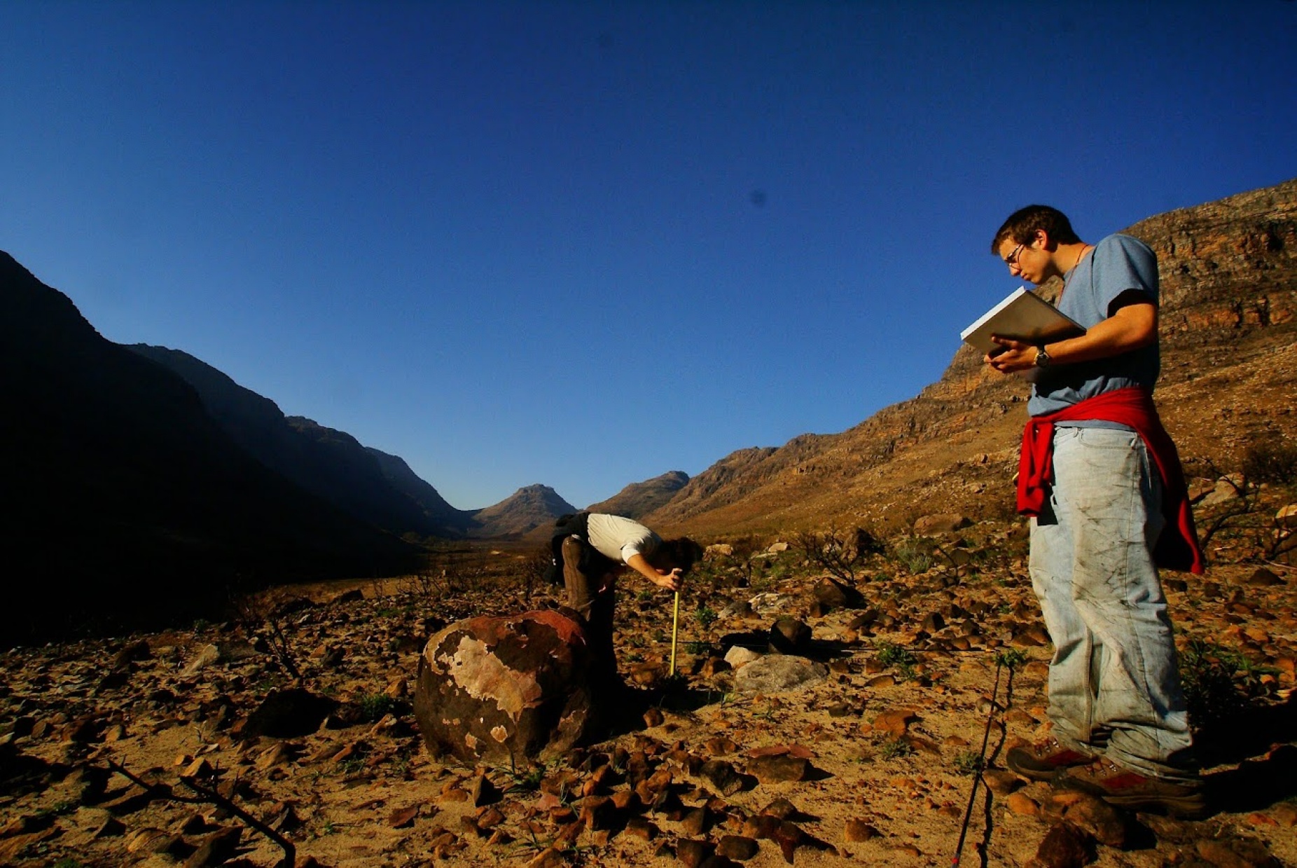 Zoom image: Students collect data on ecosystem recovery in the Cederberg Mountains in South Africa's Western Cape province, following a recent fire. BioSCape will improve scientists' ability to map and monitor ecosystem status from above. Photo: Adam Wilson 