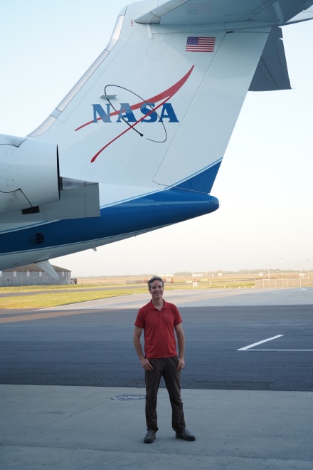 Zoom image: Wilson stands with the Gulfstream V aircraft, which will fly over the Greater Cape Floristic Region the next several weeks equipped with sensors. Photo: Adam Wilson 