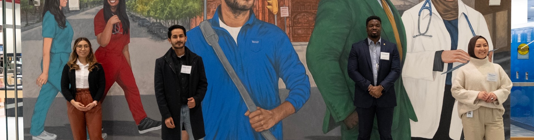 L to R: Jazmin Corral , Narayan Dhimal, Daniel Olutalabi and Parveen Attai stand in front of their images in the mural. 