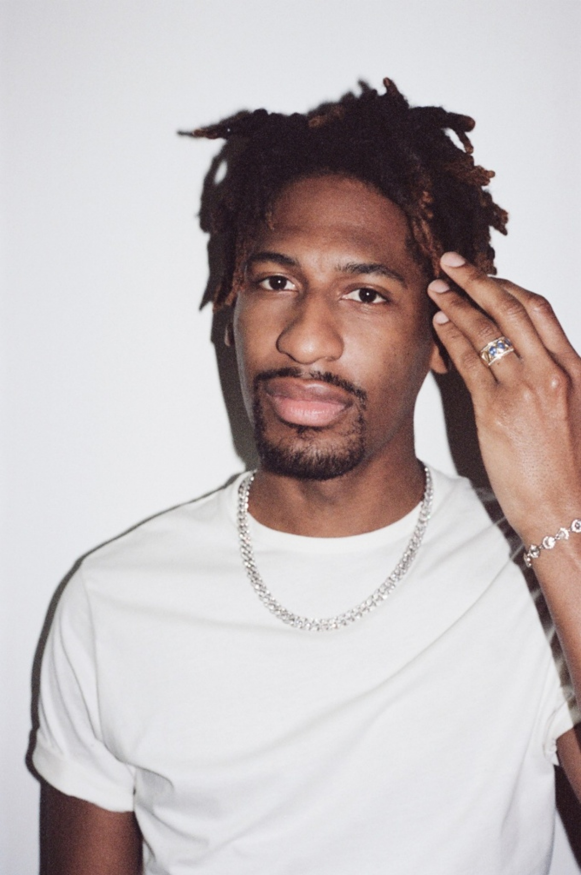 Jon Batiste in a white t-shirt. 