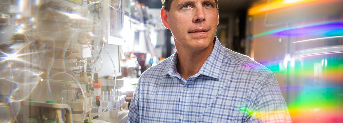 Joseph P. Balthasar sits in a pharmacy lab at UB. 