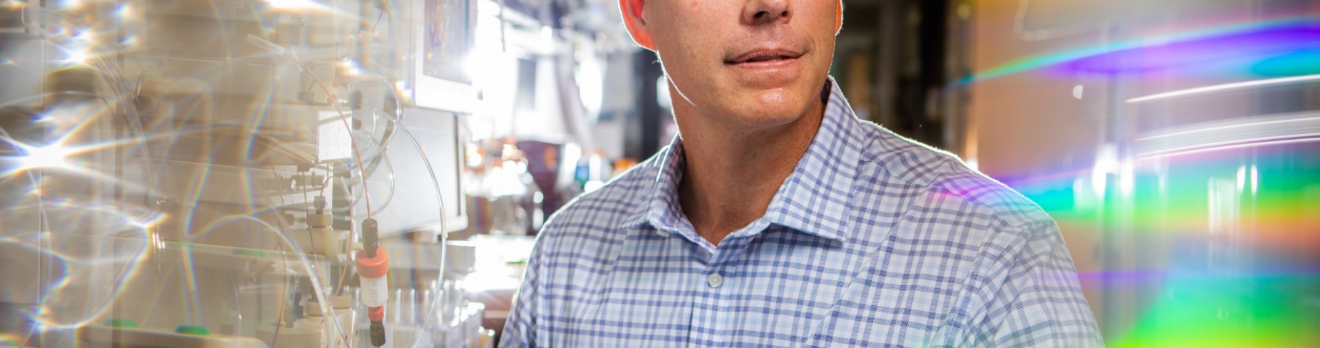 Joseph P. Balthasar sits in a pharmacy lab at UB. 