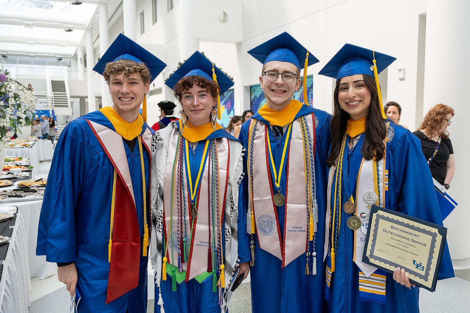 From left, Luke Hess, Lea Kyle, Bryan R. Renzoni and Sarah Bukhari pose together following their commencement ceremony. Photo: Sandra Kicman. 