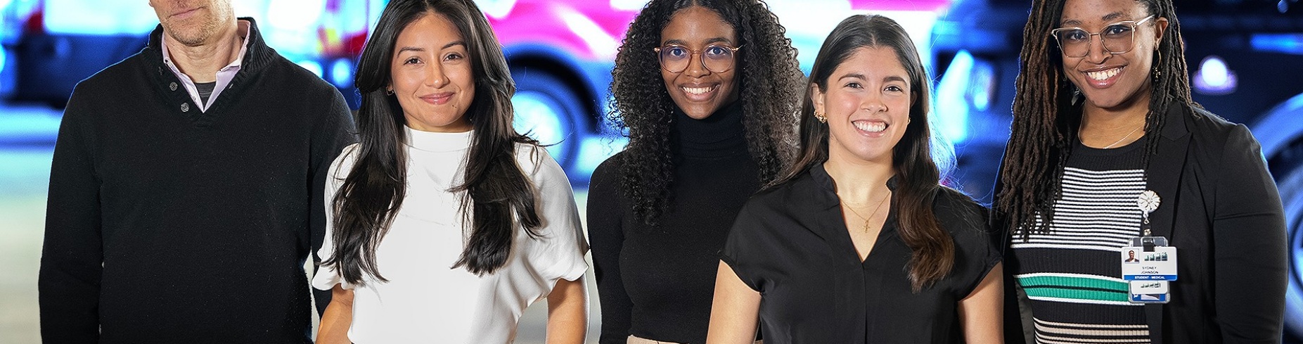 L to R: Michael Lamb, Gaby Cordero, Katherine Foote, Pia Corujo Avila and Sydney Johnson in front of an ambulance. 