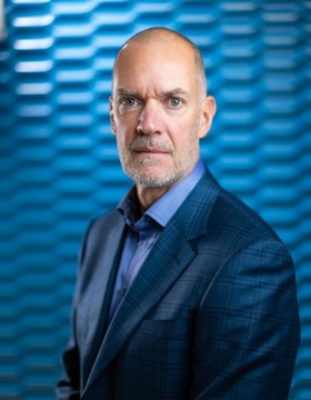Headshot of Leslie Bisson in jacket. Photographer: Douglas Levere. 