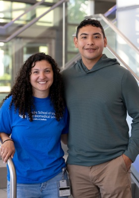 Amanda Bahgat and Frank Wolfe standing in med school lobby. 