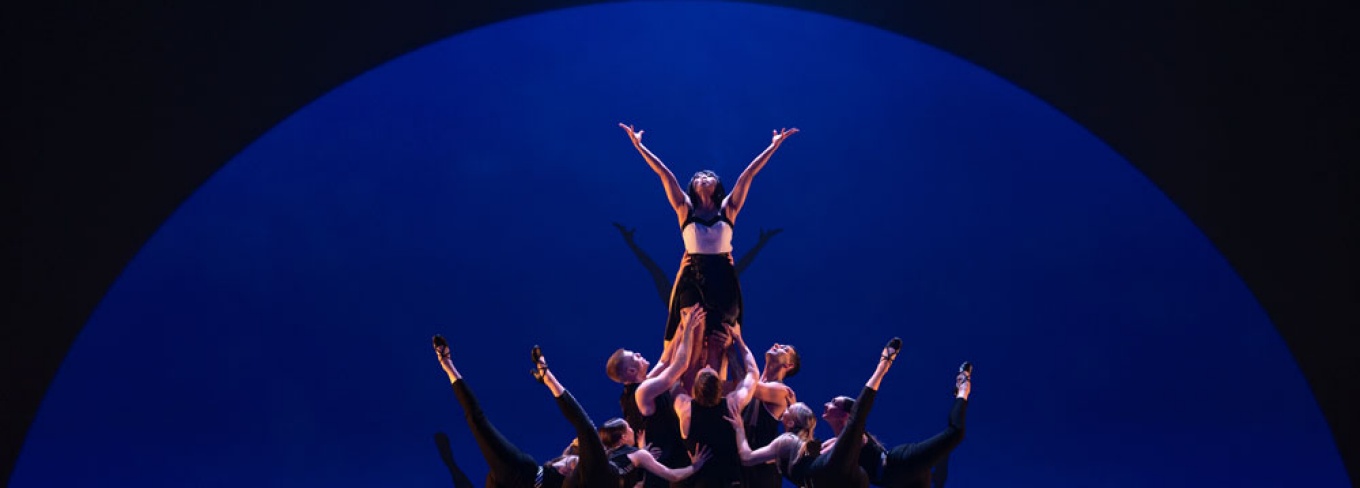 Giordano Dance Chicago on stage lifting someone in the air. 
