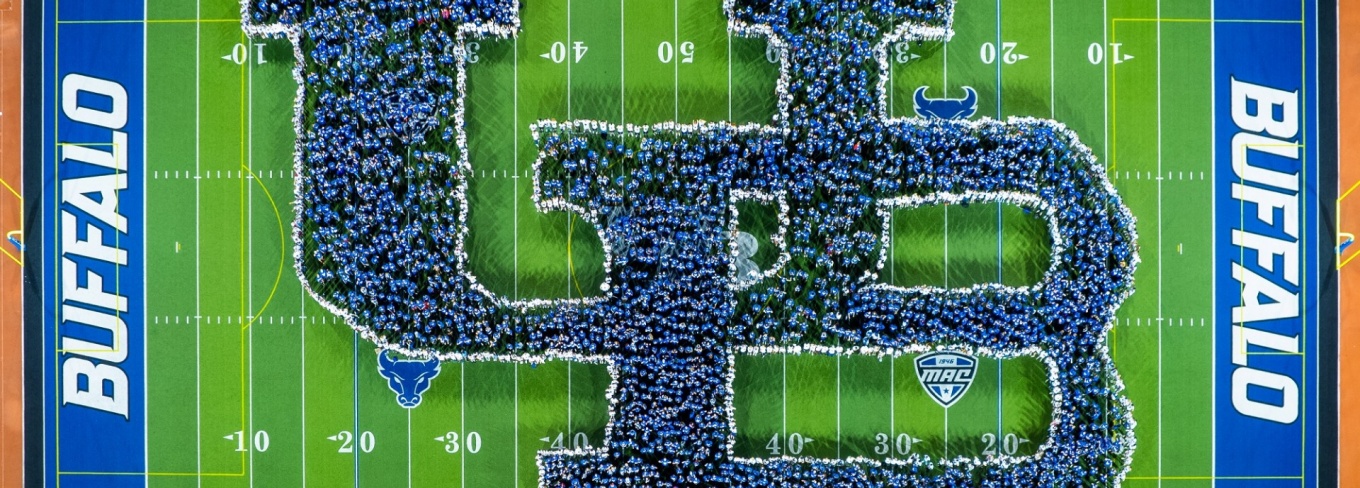 UB students create the UB logo on the football field. The view is an aerial photo.