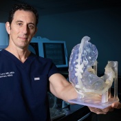 Elad Levy holding a neurological model. 