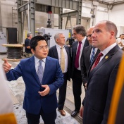 U.S. Rep. Tim Kennedy chats with UB engineering researchers in a lab setting. 