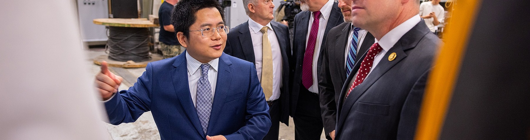 U.S. Rep. Tim Kennedy chats with UB engineering researchers in a lab setting.