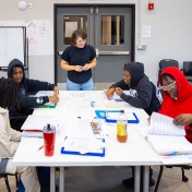 Zoom image: Laura Lubniewski, clinical assistant professor of architecture, gives instruction to, clockwise from top right, Nayaija Reid, David Clyburn, Shermarion Thomas and Seth Howard inside PUSH Buffalo's new Sustainability Workforce Training Center. Photo: Douglas Levere 