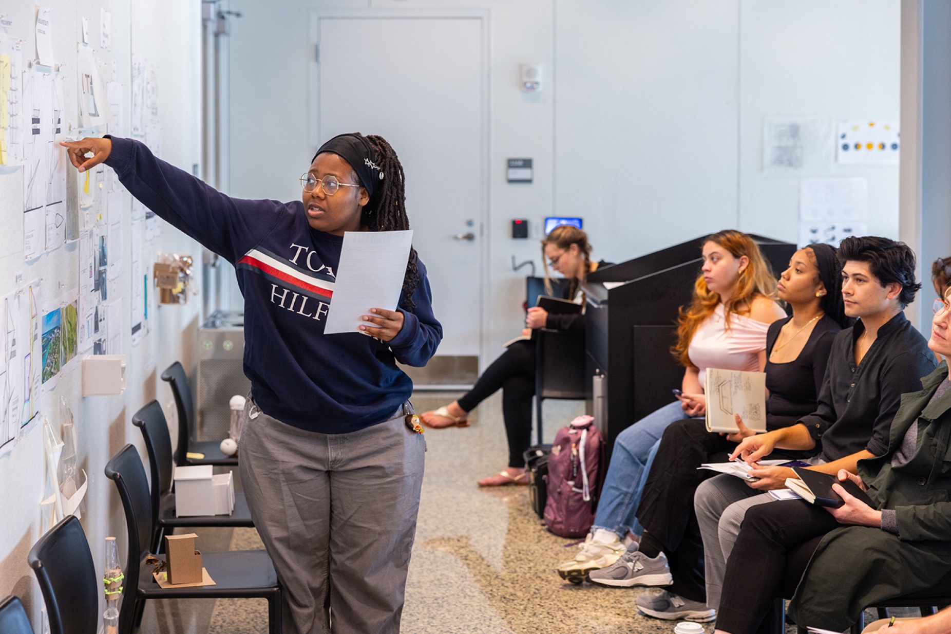 Zoom image: Lydie T. Rock Numa points to a detail while presenting a project during her architecture studio class. Photo: Douglas Levere 