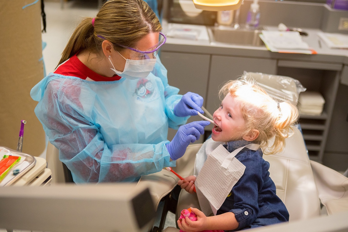 A young girl receives a dental checkup at the Give Kids a Smile event. 