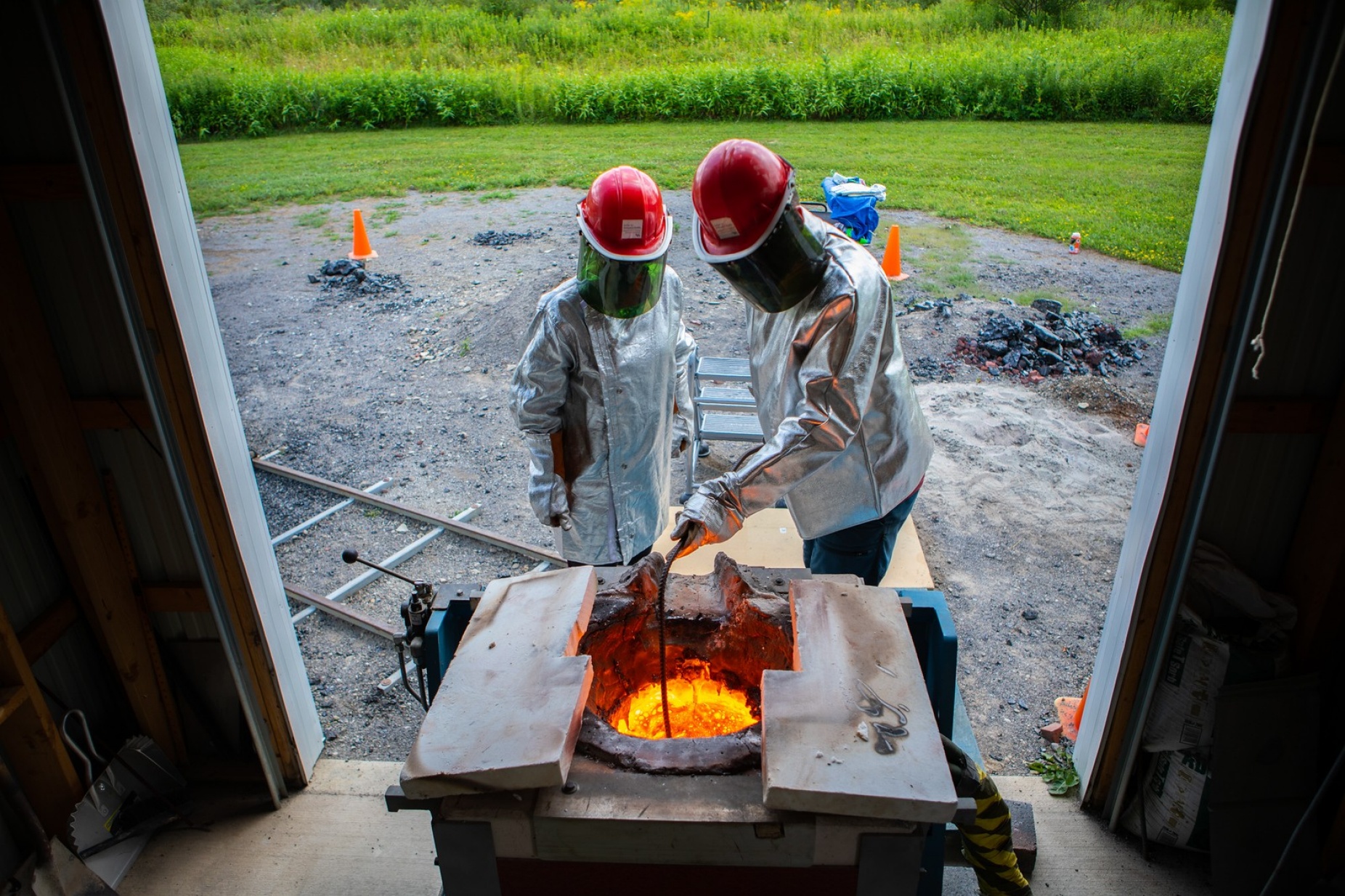 Zoom image: Assistant geology professor Stephan Kolzenburg conducts experiments at UB's Geohazards Field Station in the Town of Ashford in 2022. His research focuses on understanding the physical processes of lava. Photo: Douglas Levere/Univeristy at Buffalo 