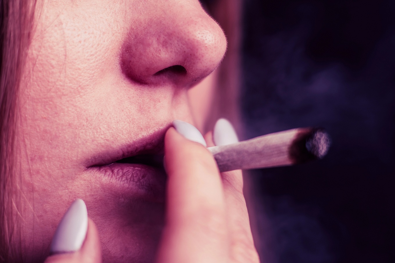 Close up of a person smoking a joint. 