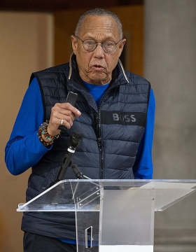 Henry Louis Taylor, speaking from a podium. 