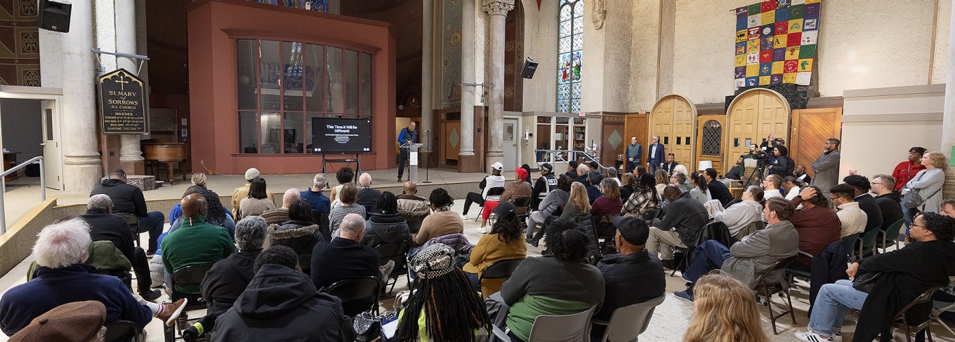 Henry Louis Taylor speaks to attendees at a "Transforming the Black East Side" meeting. 