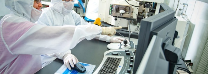 Researchers work inside the clean room at Davis Hall. 