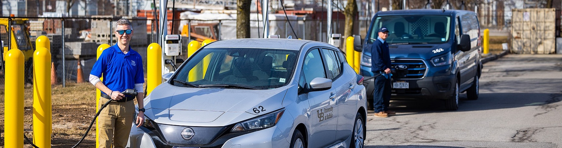 Zoom image: Nate Bolt, assistant director of construction delivery in UB Facilities, gets ready to charge up one of the university&rsquo;s fleet electric vehicles at the new station in the Beane parking lot. Photo: Douglas Levere/University at Buffalo 
