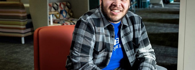 Sophomore Travis White poses while sitting on a chair. Photo: Meredith Forrest Kulwicki. 