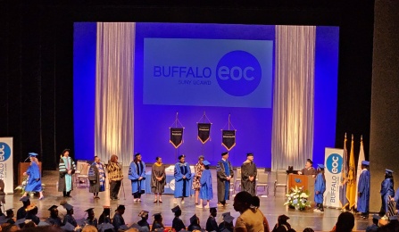 Overhead view of students on stage at previous Buffalo Educational Opportunity Center commencement.