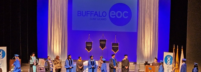 Overhead view of students on stage at previous Buffalo Educational Opportunity Center commencement.