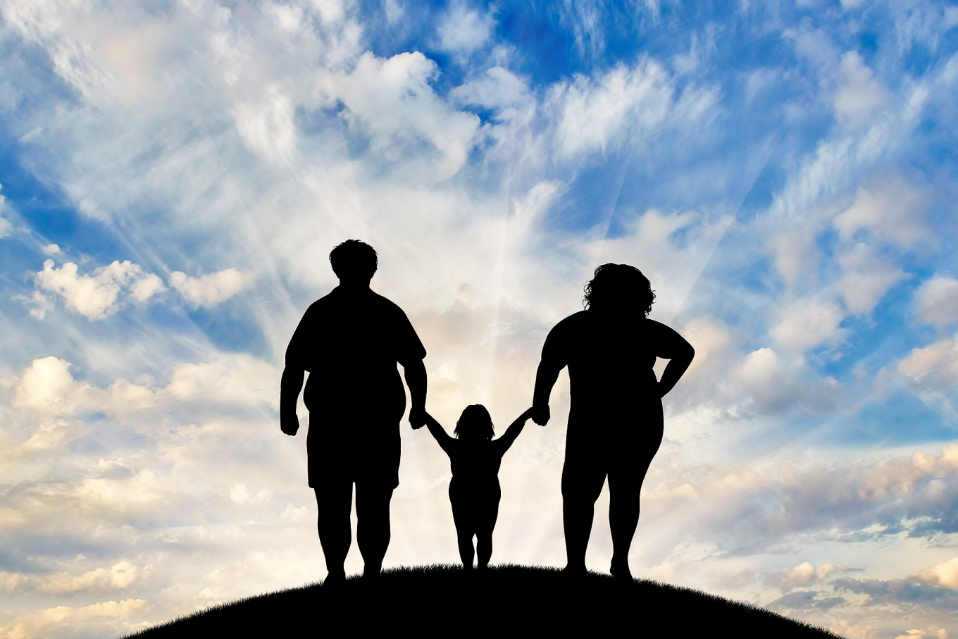 Concept of a bright future for a family struggling with obesity featuring silhouettes of three family members standing on a hill with a bright blue sky in the background..