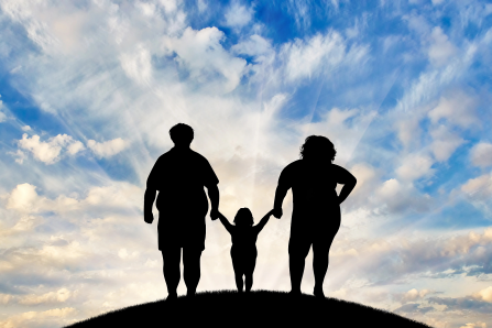 Concept of a bright future for a family struggling with obesity featuring silhouettes of three family members standing on a hill with a bright blue sky in the background..