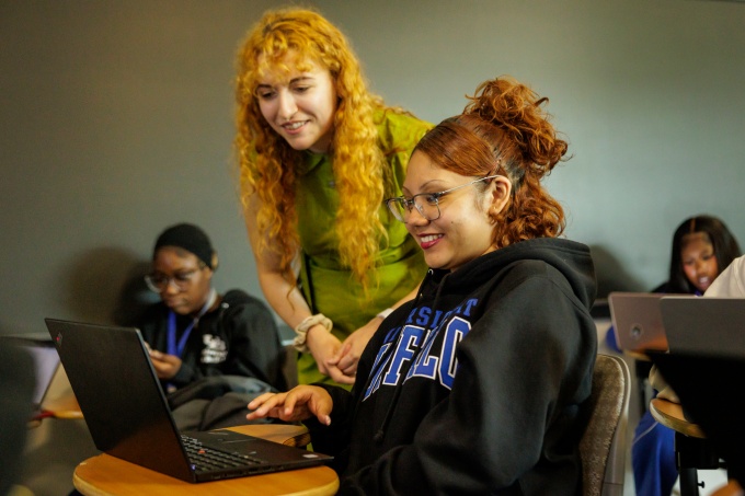 An EOP instructor works with a student in the classroom.