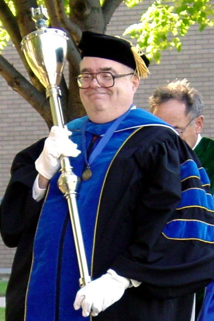 Peter Nickerson, pictured carrying the University Mace during a 2003 Convocation. 