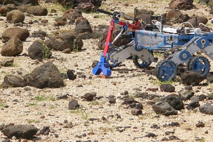 Zoom image: UB's rover collects rock samples, one of the tasks required in the competition. 