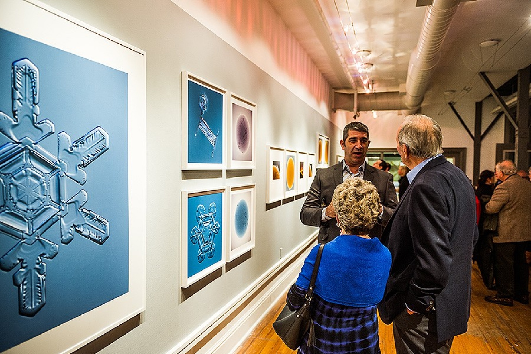 Doug Levere chatting with attendees at reception. 