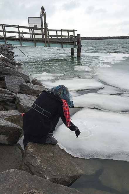 Zoom image: Shelley Jackson writes a word in a patch of ice along the Outer Harbor for her Instagram-based story "Snow." Photo: Christina Milletti 
