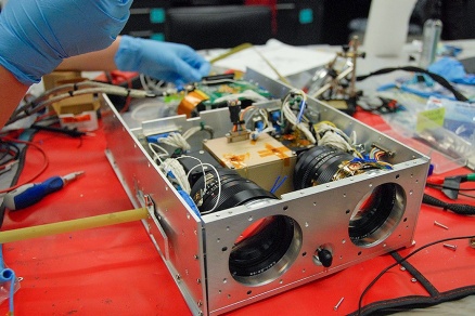 Zoom image: The engineering unit version of UB Nanosatellite Lab's GLADOS satellite in the midst of assembly. Photo: UB Nanosatellite Lab 