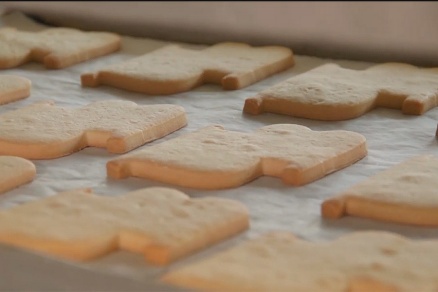 Zoom image: The cookies are hand-cut with a special "UB logo" cutter and then piped with white and "UB blue" frosting. 