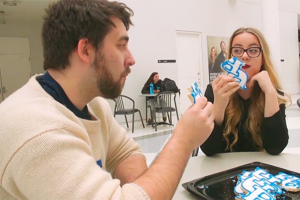 Zoom image: Students enjoy the UB cookie. 